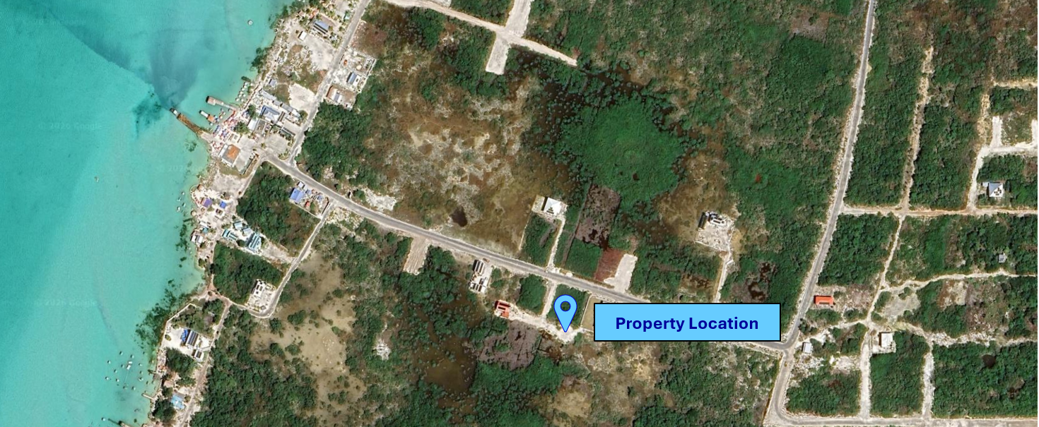Wider aerial view showing the property and surrounding area.