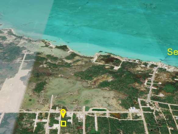 Mid-range drone shot of an Ambergris Caye lot showing proximity to the Secret Beach waterfront.